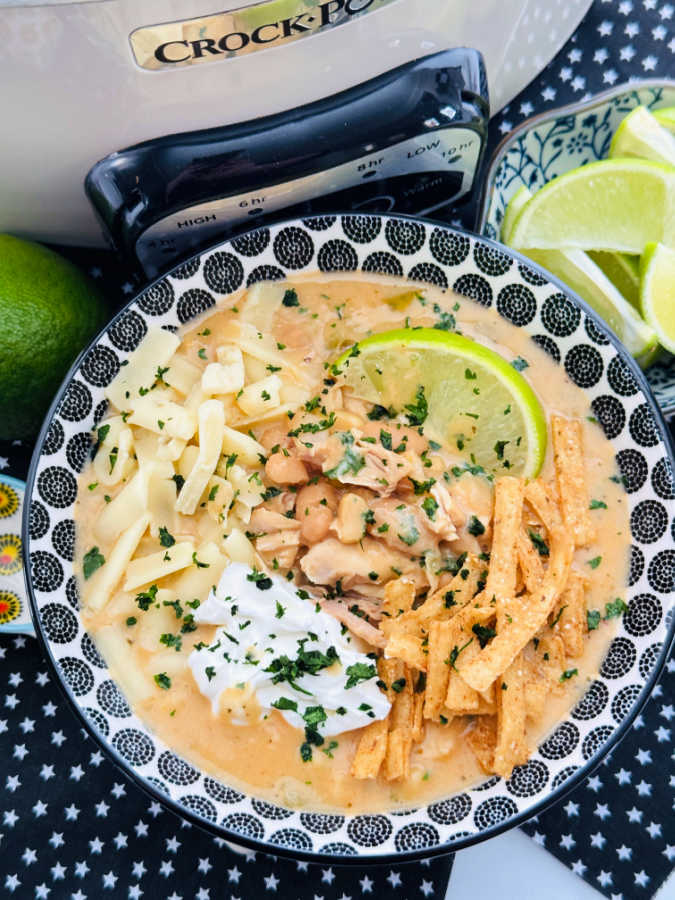 a bowl full of crockpot white chicken chili ready to serve