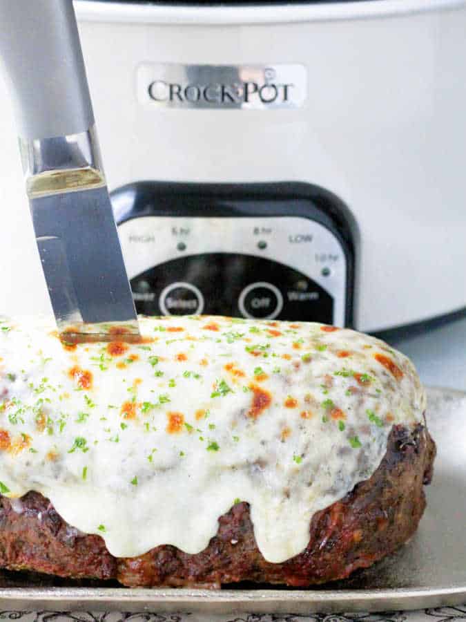 whole French Onion Meatloaf ready to serve and topped with lots of melted cheese