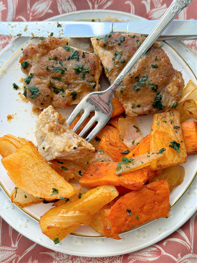 taking a bite of applesauce baked pork chop