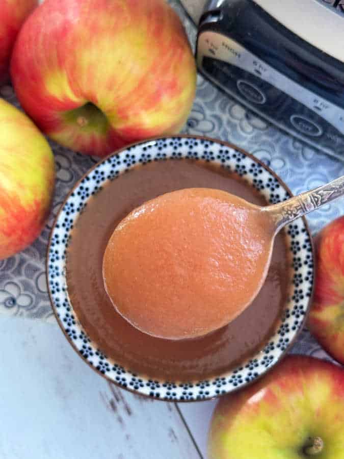 showing a close-up spoonful of slow cooker applesauce