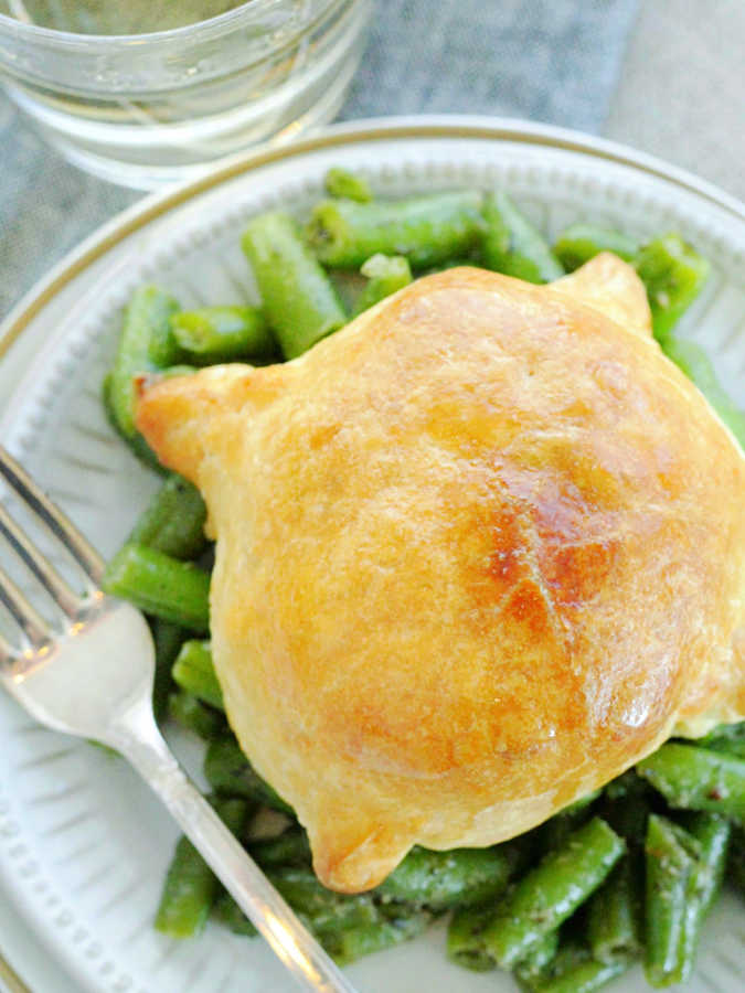 a pork wellington wrapped in crispy puff pastry