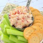 a bowl of homemade pimento cheese with celery sticks and Ritz crackers for dipping