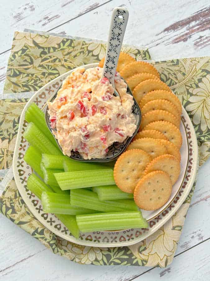 the best pimento cheese dip plated with celery sticks and Ritz crackers 
