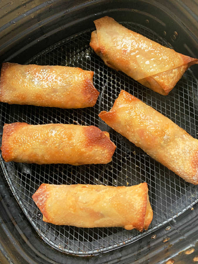 five southwest egg rolls in the basket of my air fryer