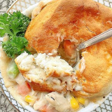 This recipe for Air Fryer Pot Pie makes four individual pies. A creamy chicken and vegetable stew combines with biscuit tops.