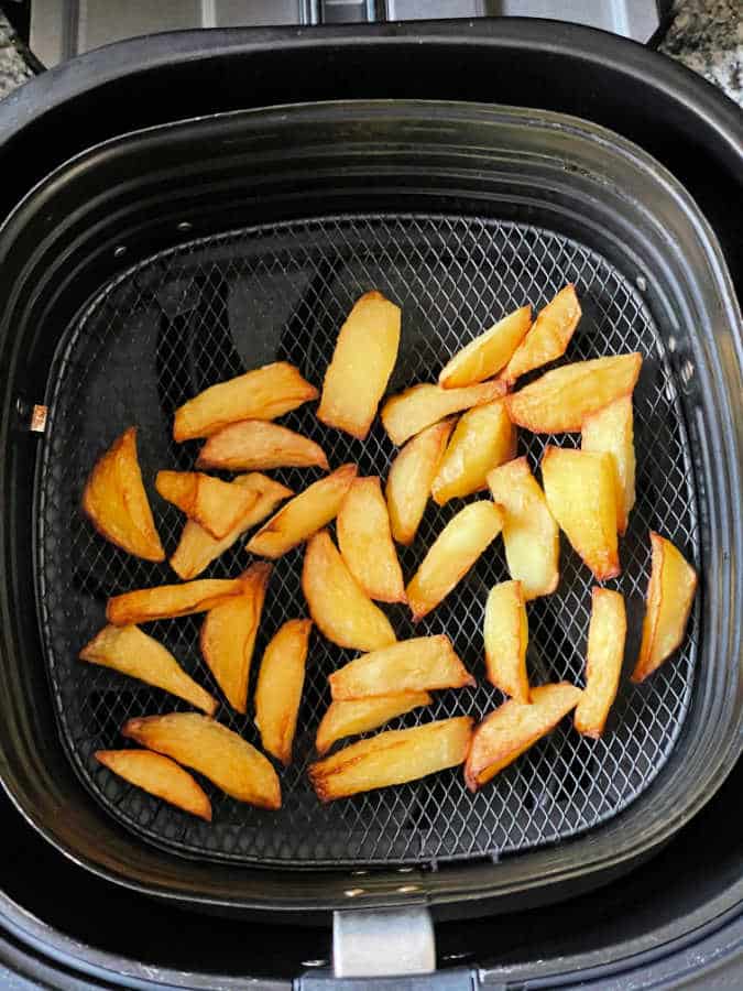 fried apple in the basket of an air fryer