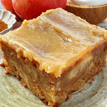 a slice of glazed apple dapple cake on a plate