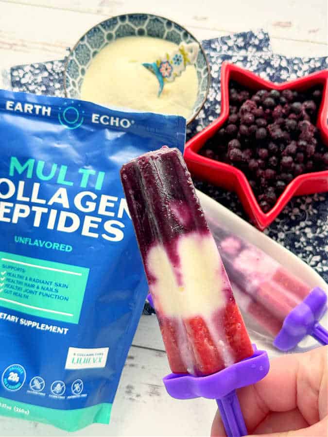 a red white and blue collagen popsicle ready to eat - it includes Earth Echo brand multi collagen peptides mixed with frozen blueberries, raspberries and vanilla Greek yogurt