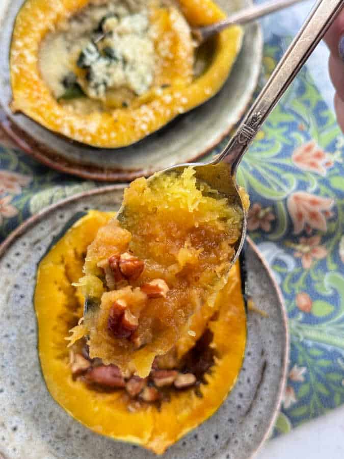 taking a bite of buttery brown sugar pecan acorn squash