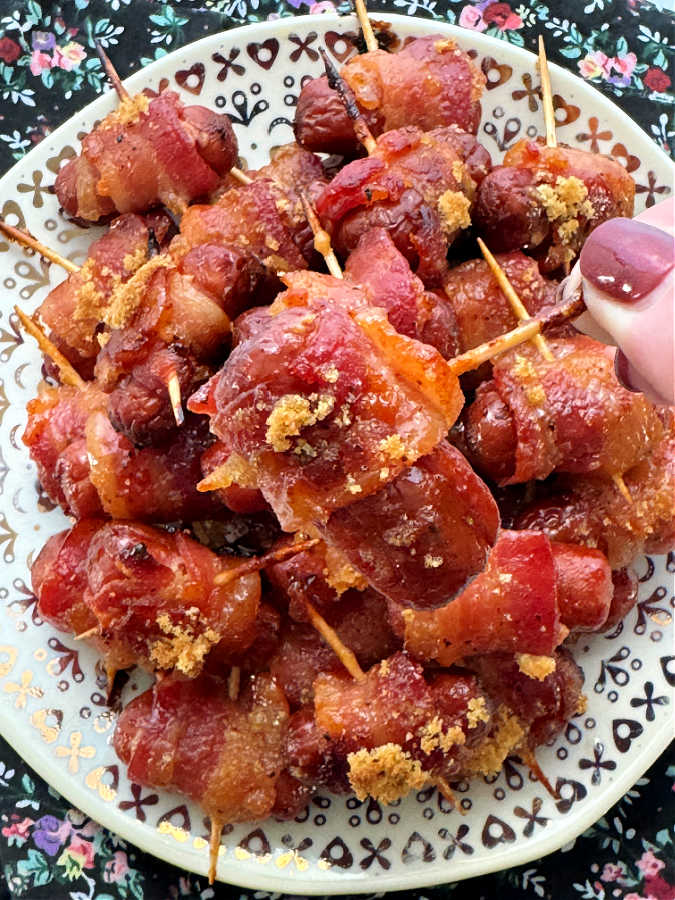 showing a close up of a smoked sausage wrapped in bacon