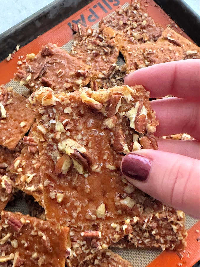 holding a praline graham square to show it up close