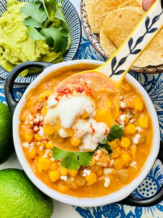 close up photo of a spoonful of corn chowder